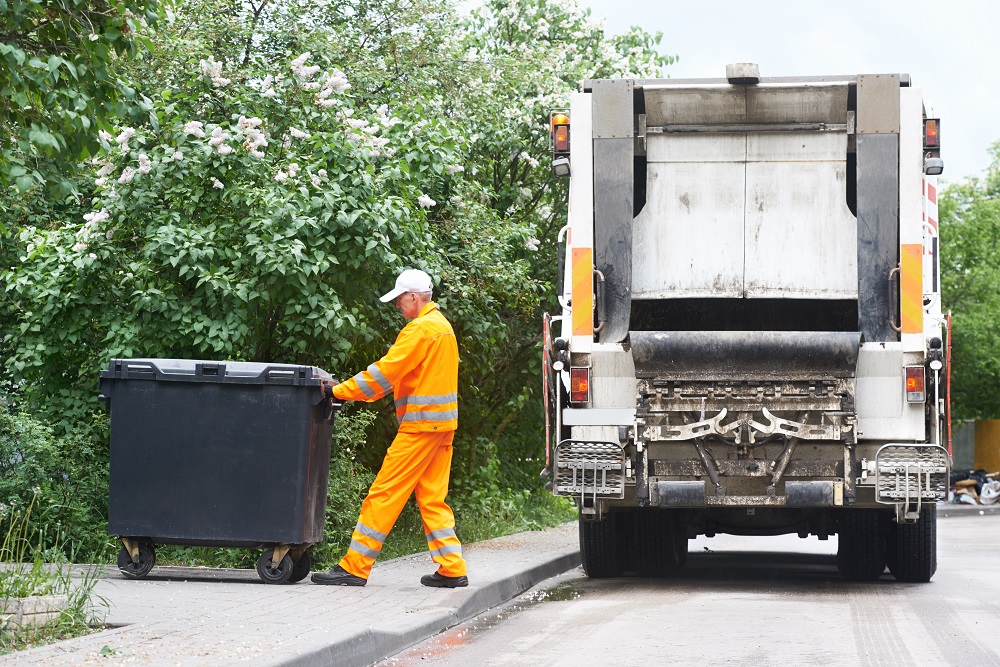 Man putting away the waste bin