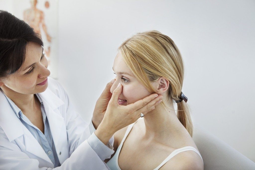 Nose being checked by the doctor