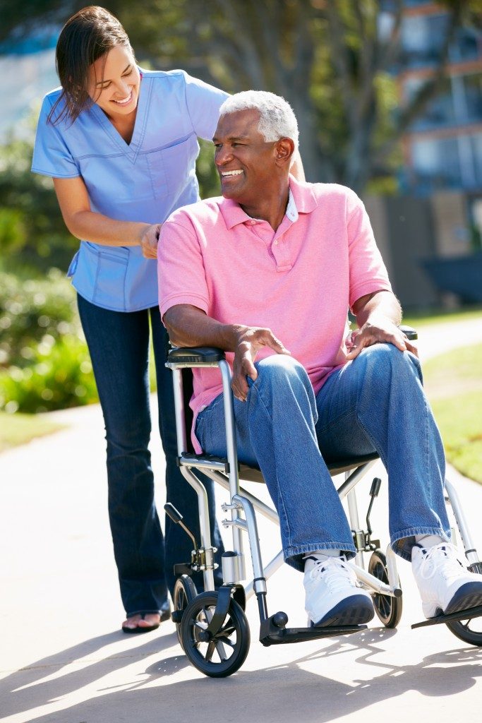 elderly man being assisted by care taker