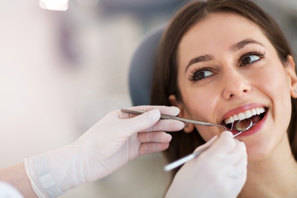 beautiful girl having her teeth checked