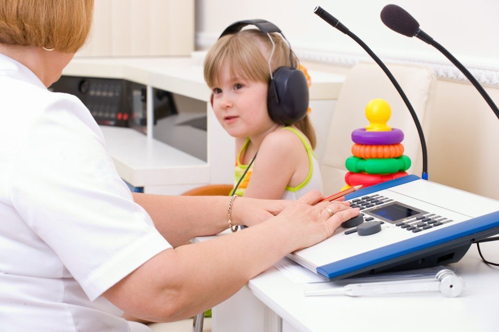 doctor testing child's audio