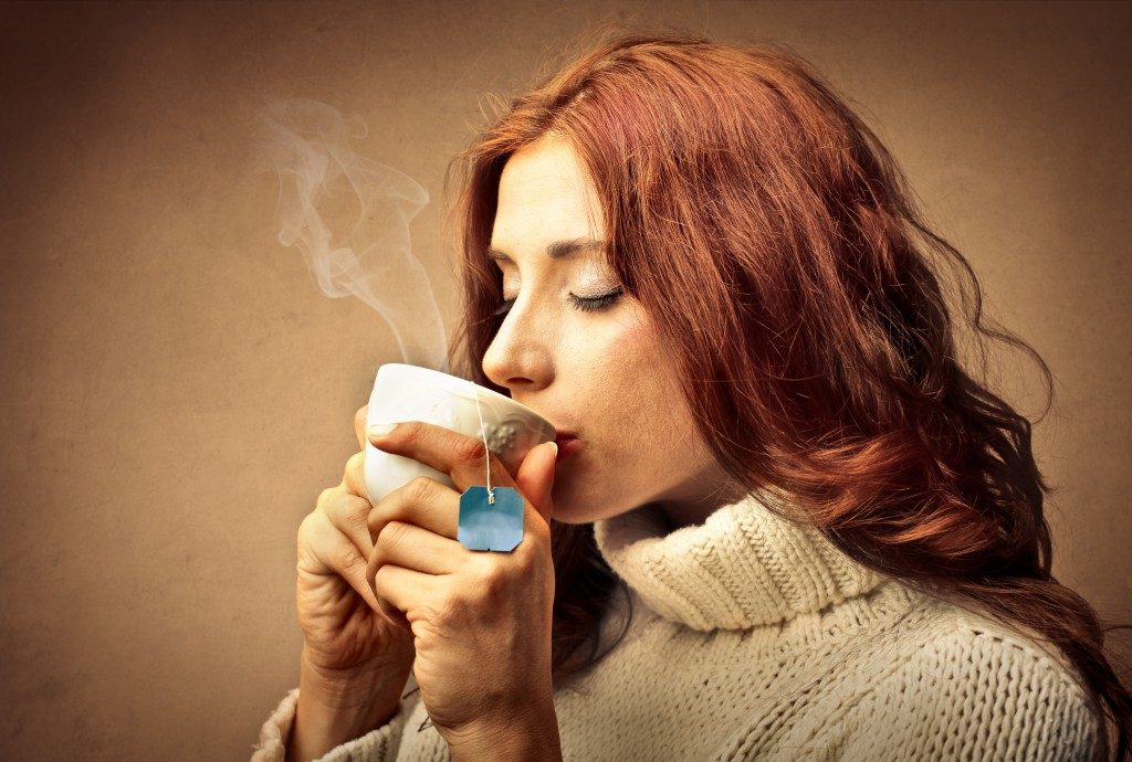 Female drinking warm tea