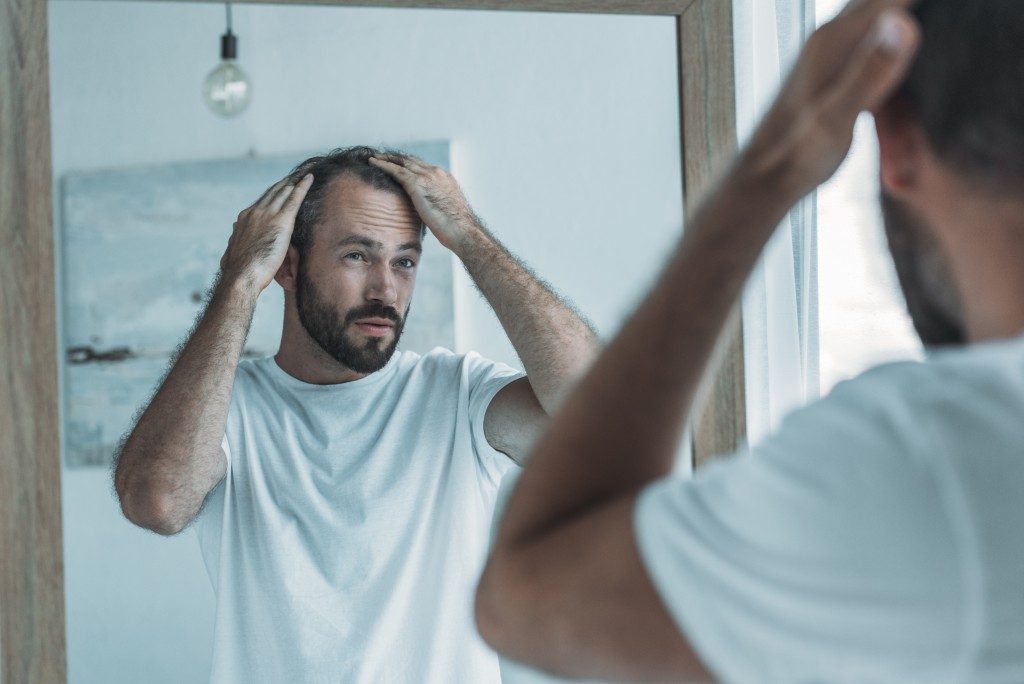 man touching his hair