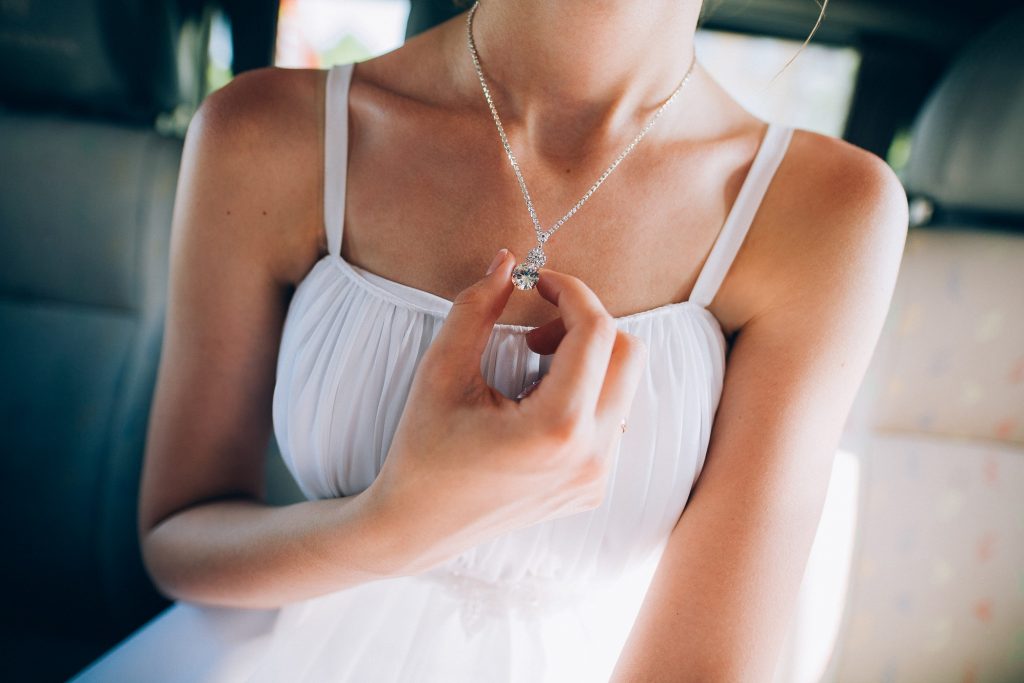 lady wearing beautiful necklace in a simple clothing