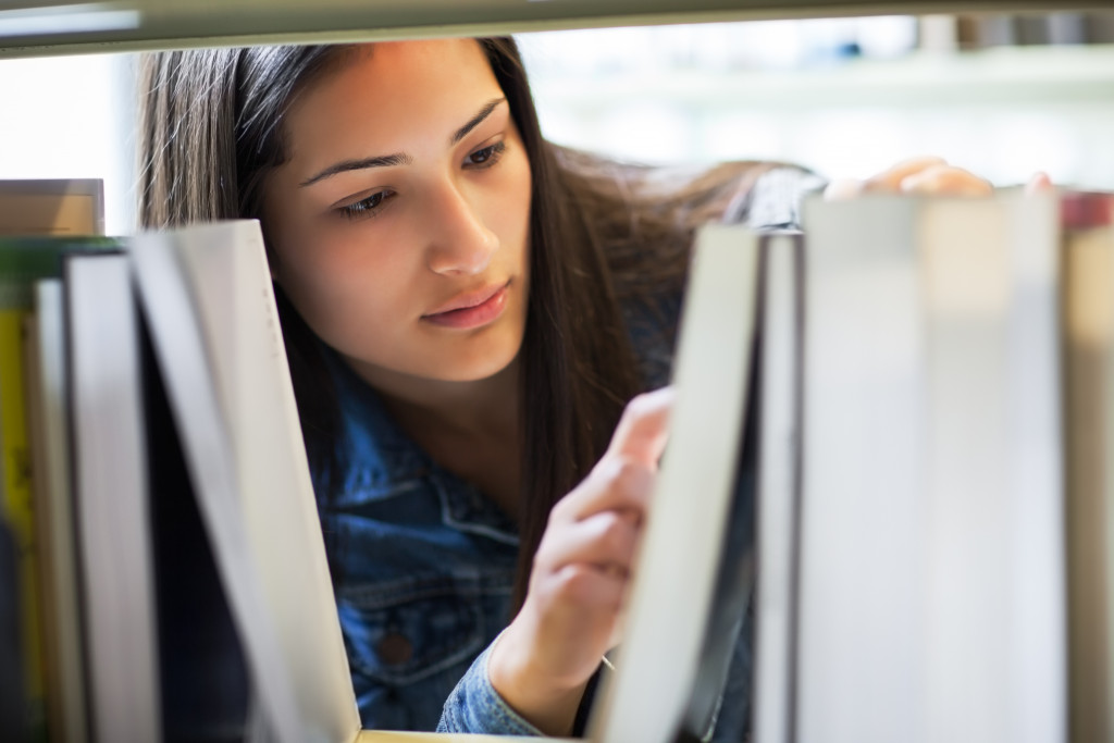 Female looking through library books