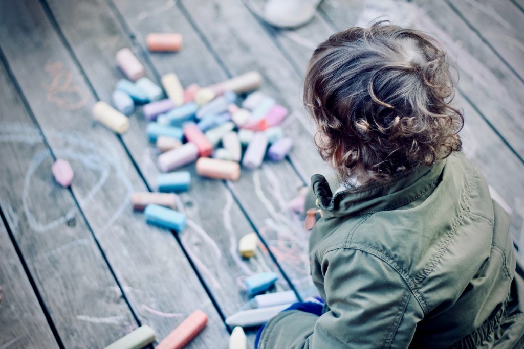 Boy playing with coloring materials