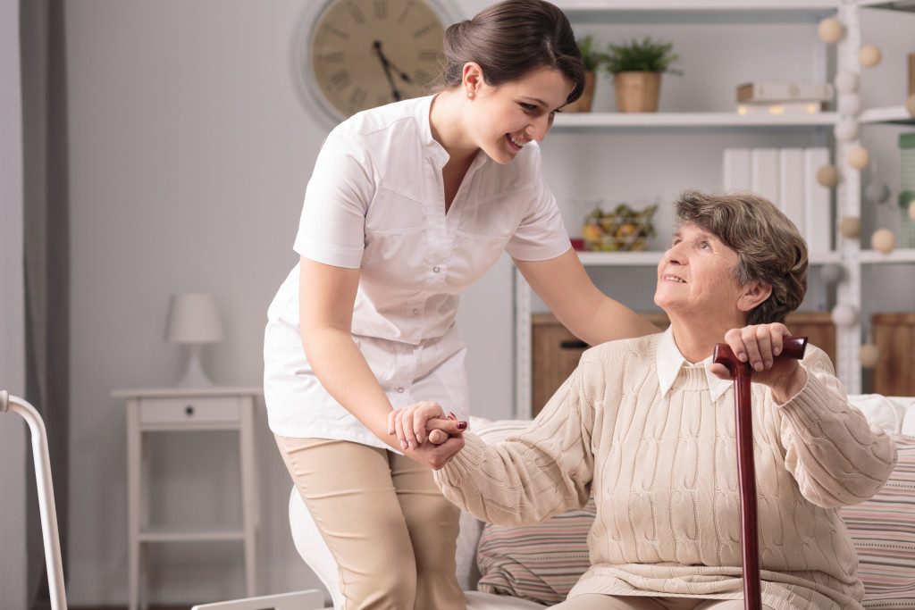 young woman helping elder woman