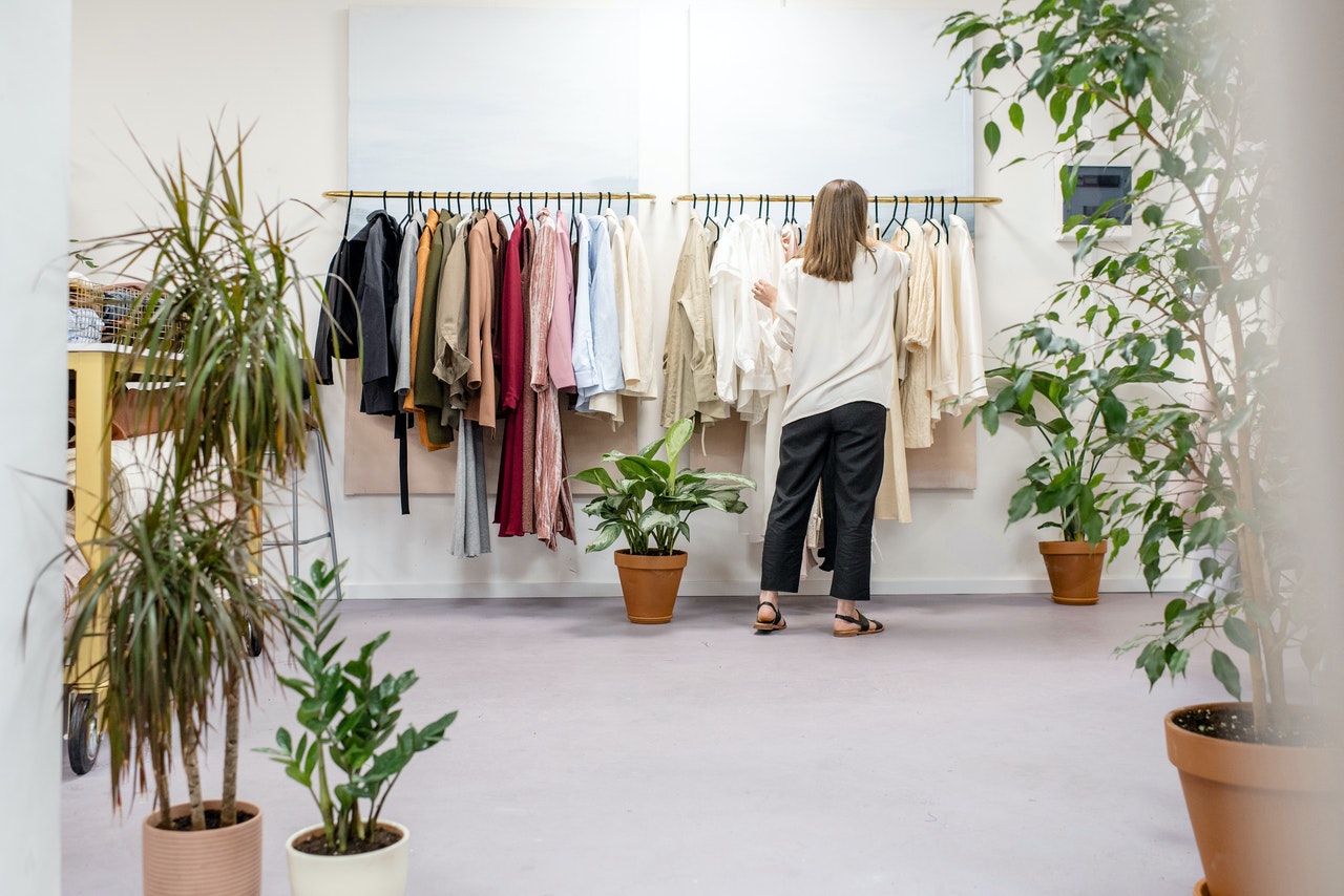 woman looking at clothes rack