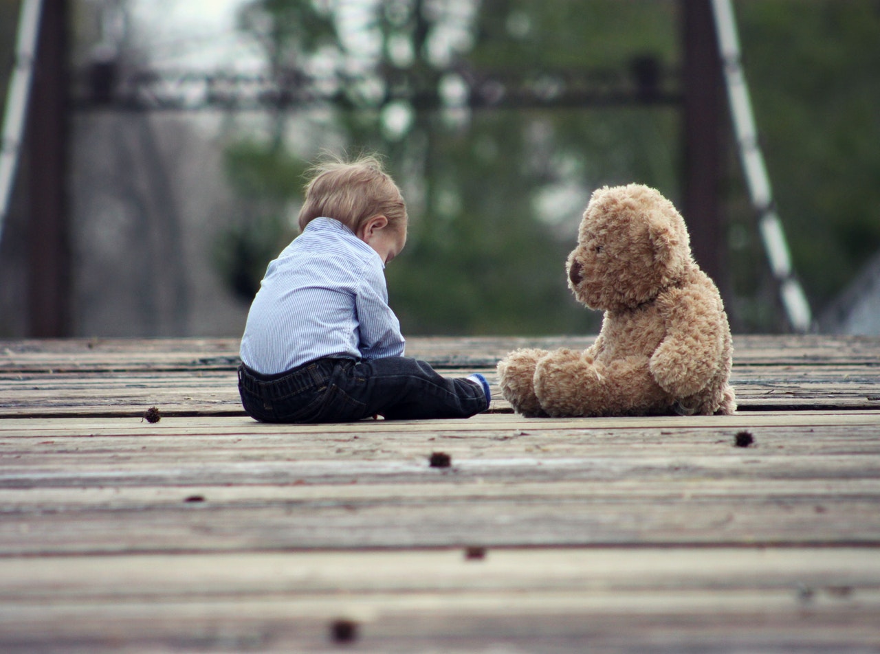 toddler sitting with teddy bear