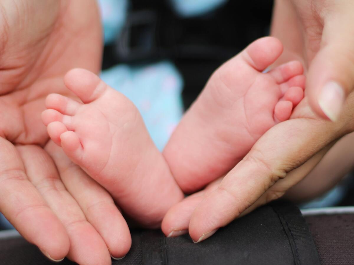 parents holding baby's feet