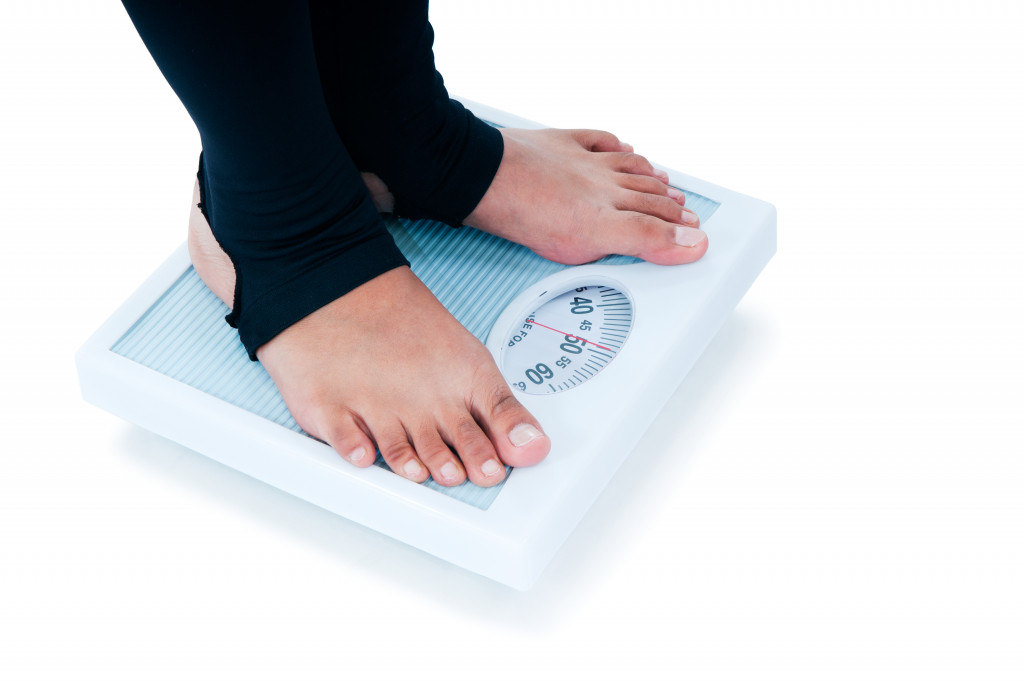 A person standing barefoot on a weighing scale