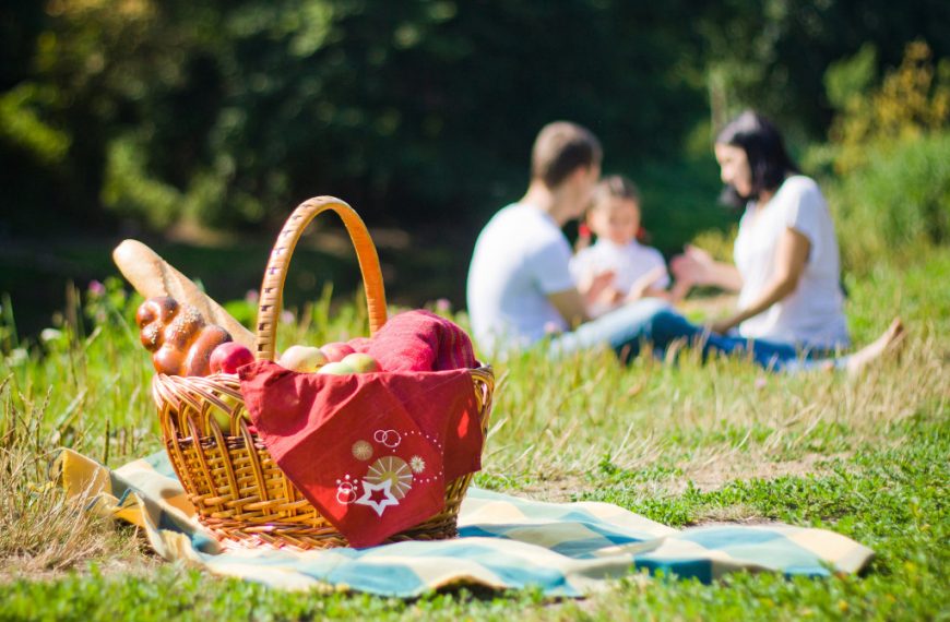 a picnic basket with a healthy family at the back