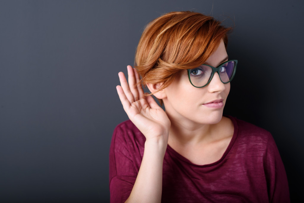 A woman trying to hear something