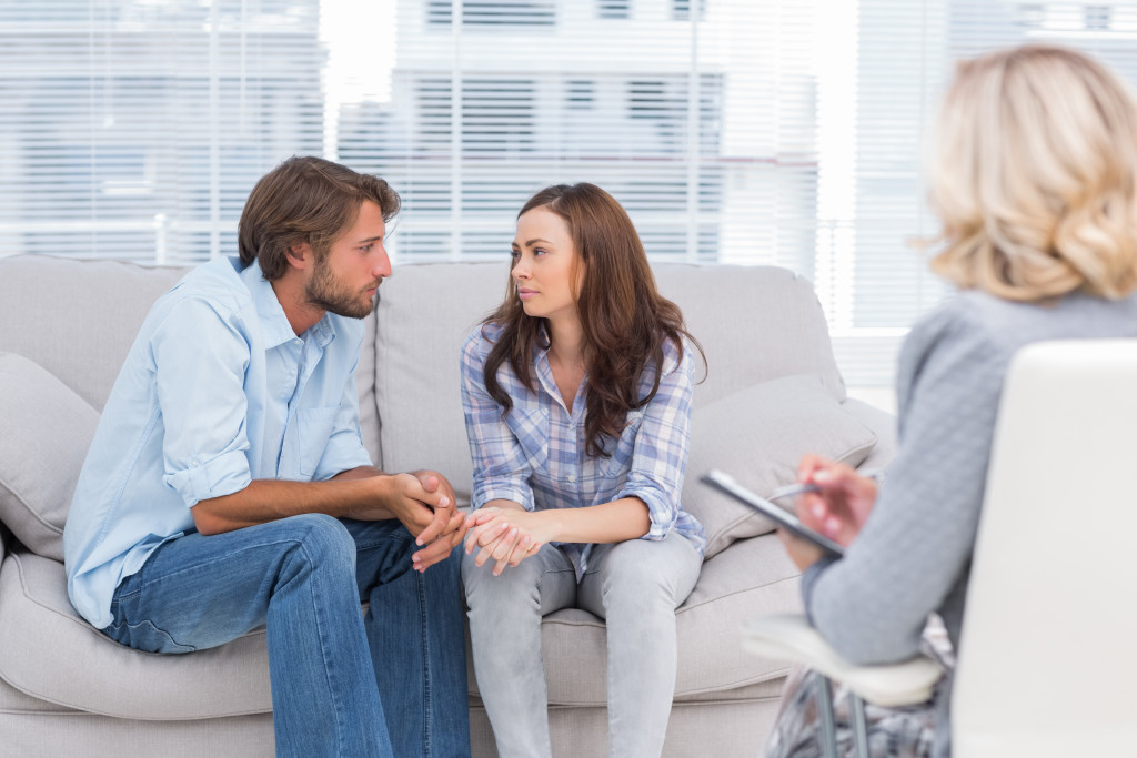 man and woman talking together in front of counselor