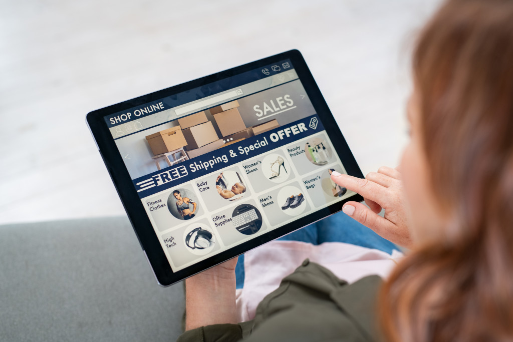 a woman holding a tablet for an online fashion business