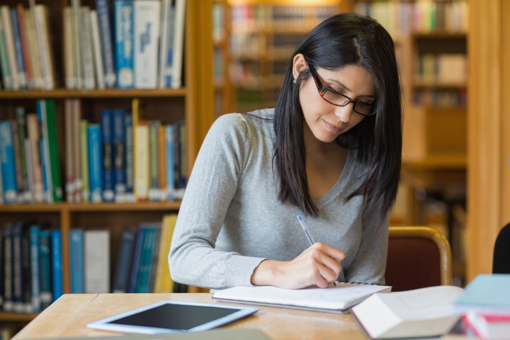 a woman at a library taking notes