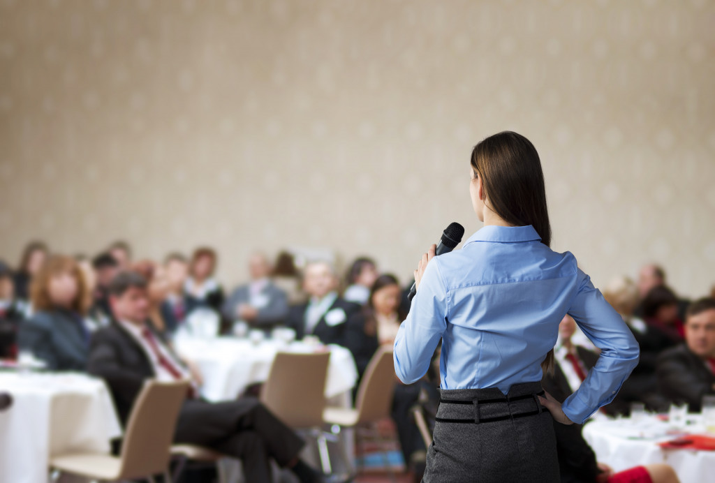 a woman standing straight in front of a crowd