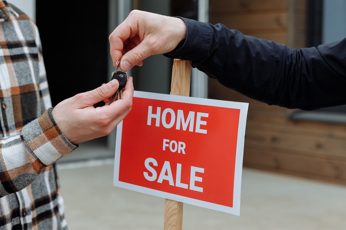 real estate agent handing over keys to buyer