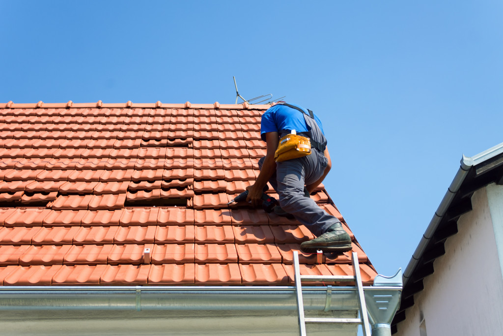 a man repairing roof damage