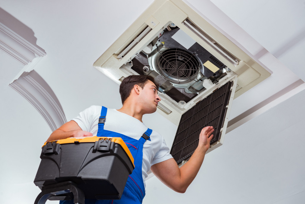 a man inspecting the AC unit