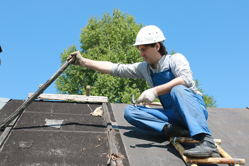 a man checking the condition of the roof