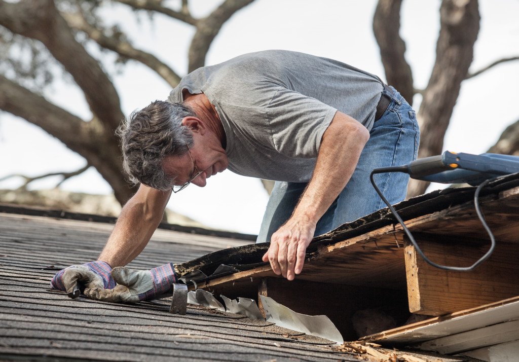 Homeowner performing roof maintenance